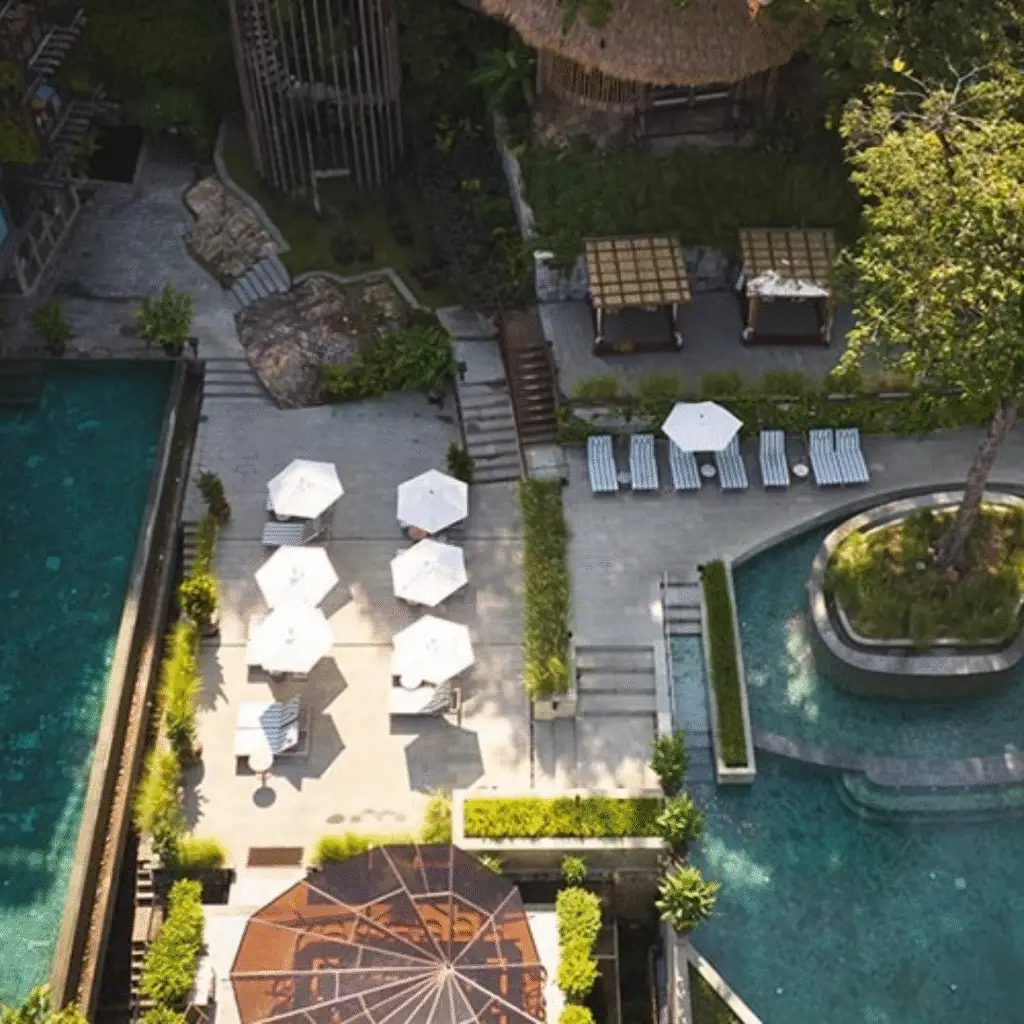 Aerial view of multi-level pools, cabanas, and lounging areas at Dinso Resort