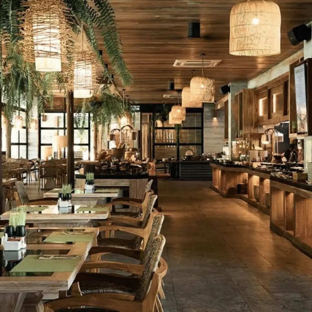 Natural wood-accented dining area with buffet setup and rattan lighting at Dinso Resort’s restaurant