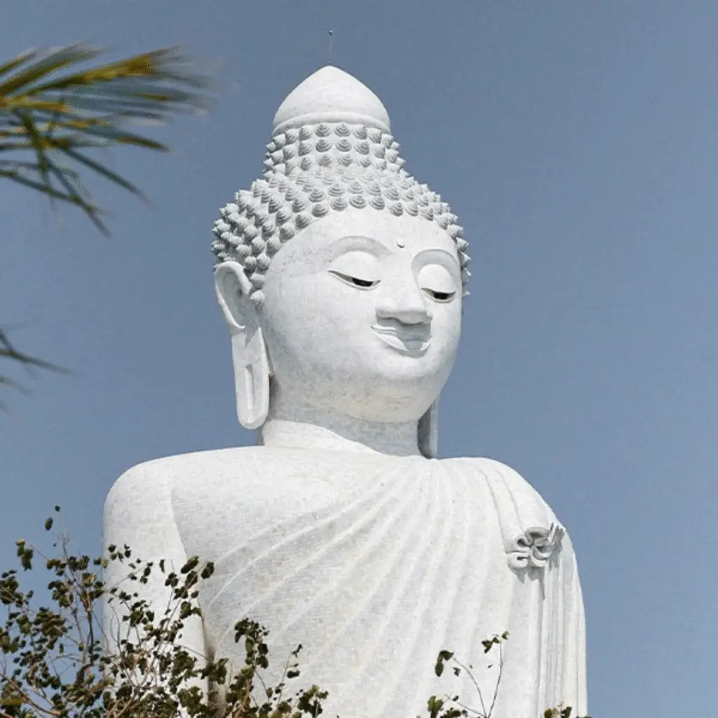 White marble Big Buddha statue against a blue sky in Phuket