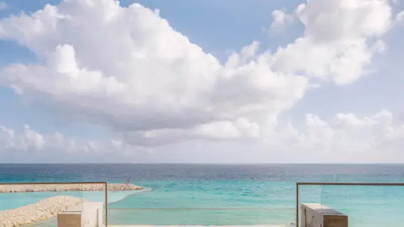 Tranquil private plunge pool with open sky and endless views of the turquoise Caribbean Sea.
