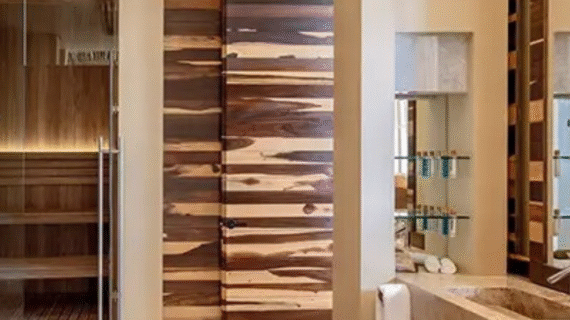 Modern spa-style bathroom featuring natural wood finishes, a glass sauna, and premium amenities.