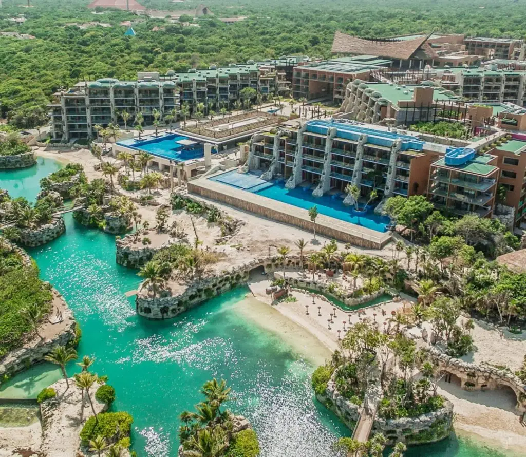 Aerial view of Hotel Xcaret México showcasing rivers, jungle, and oceanfront location.