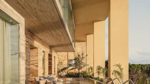 Elegant wooden deck with water therapy jets and plush circular loungers under warm golden light.