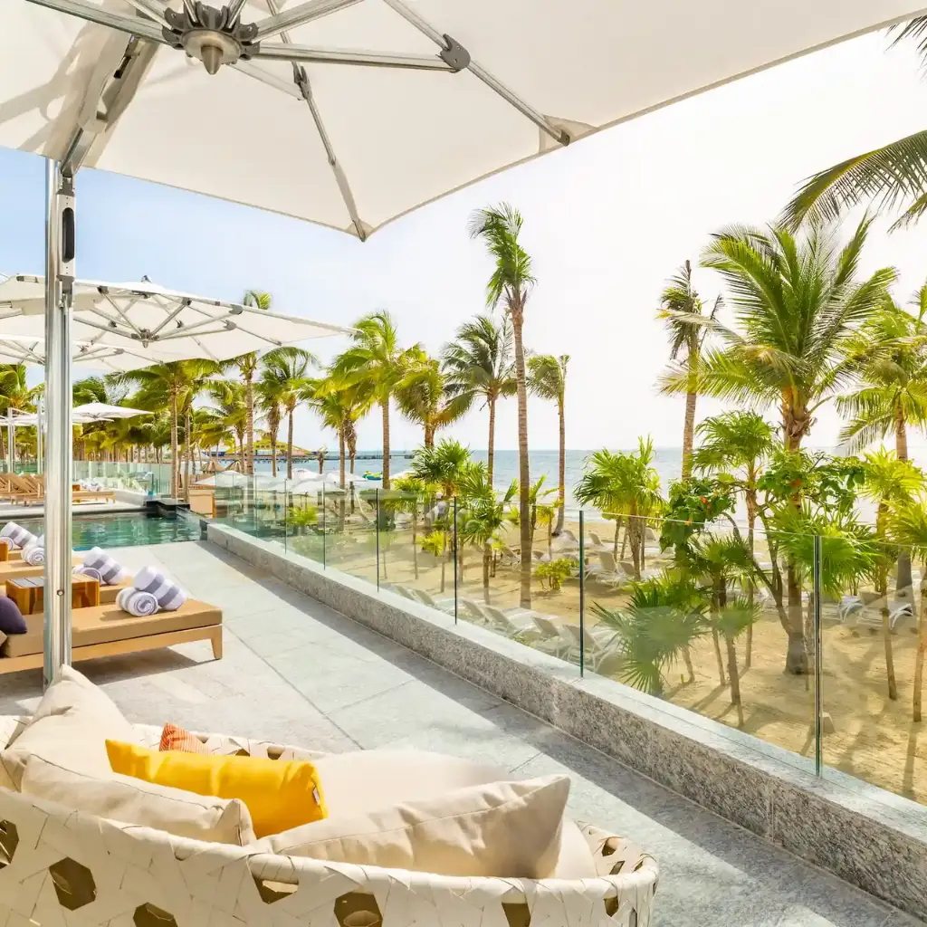 Tranquility at the pool of Hotel Mousai Cancun, with lounge chairs and umbrellas shaded